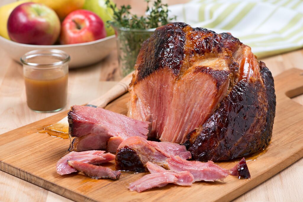 Sweet and southern slow cooked ham platted with a side of gravy and apples