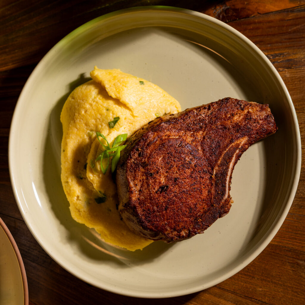 Blackened Pork Chops with Cheesy Bacon Grits ​